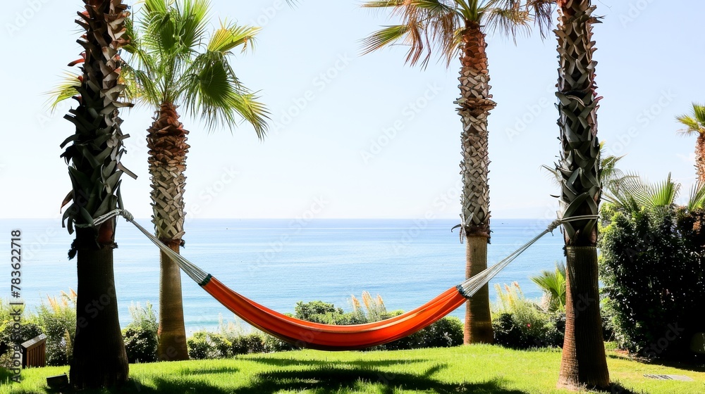 A hammock strung between palm trees, the azure sky and sea creating a backdrop of pure bliss and relaxation.