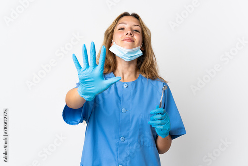 Woman dentist holding tools isolated on white background counting five with fingers