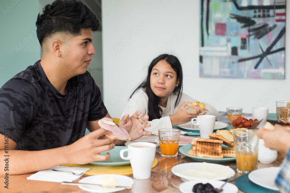 Sister and brother having breakfast together in the dinning room. Sister and brother having breakfast together in the dinning room.