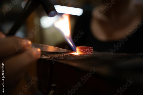 Closeup of forging a silver ring at the smith photo