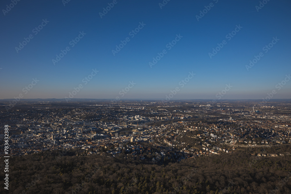 Scenic cityscape of Stuttgart with dense buildings and trees under the blue clear sky