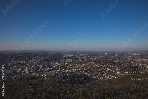 Scenic cityscape of Stuttgart with dense buildings and trees under the blue clear sky