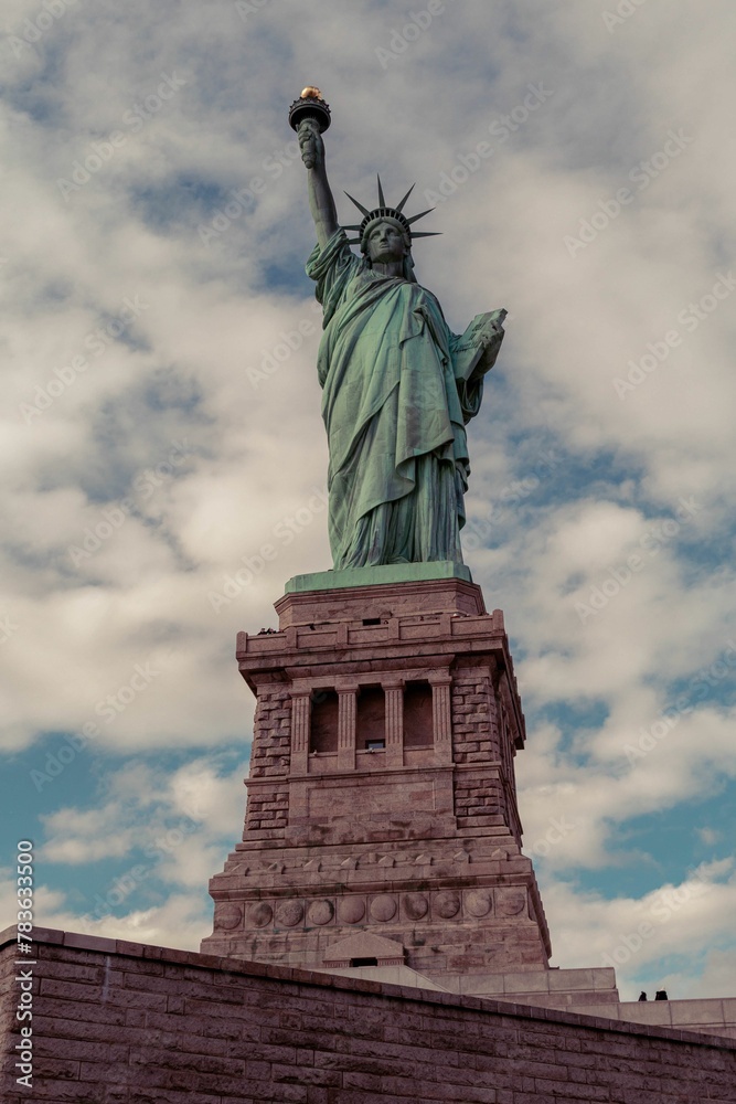 Statue of Liberty in New York against a backdrop of dark clouds