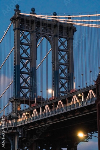 Vertical low angle shot of the Manhattan bridge in New York, during sunset hours © Wirestock