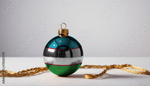 A Christmas tree ornament featuring the Uzbekistan flag, symbolizing holiday cheer and patriotic spirit photo