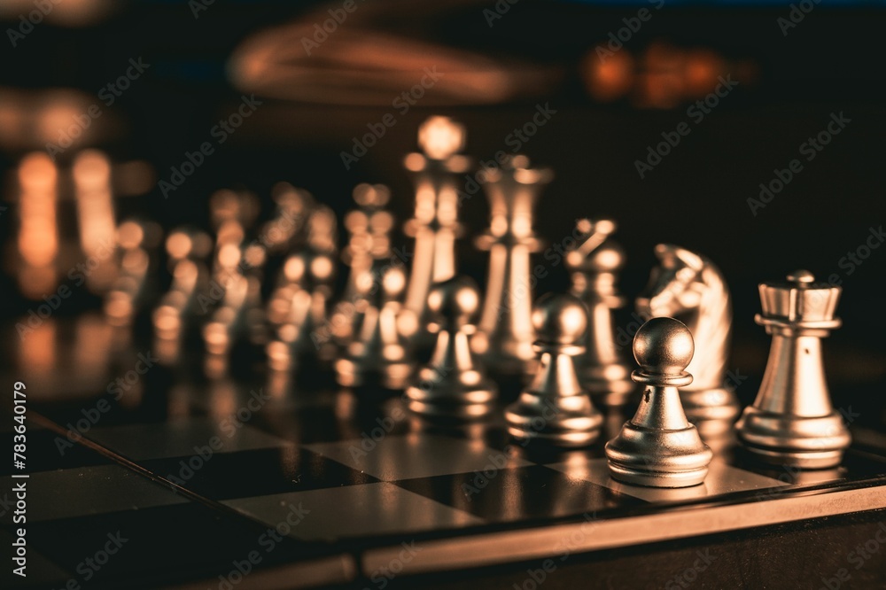 Close-up shot of silver chess pieces on a chessboard Close-up shot of silver chess pieces on a chessboard