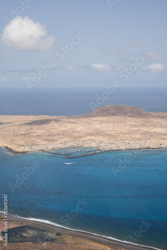 Views of the island of La Graciosa from the viewpoint of El Rio. Turquoise ocean. Blue sky with big white clouds. Caleta de Sebo. Town. volcanoes. Lanzarote  Canary Islands  Spain