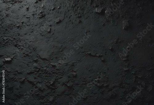 close up view of dark paint on the wall, with some scattered rocks photo