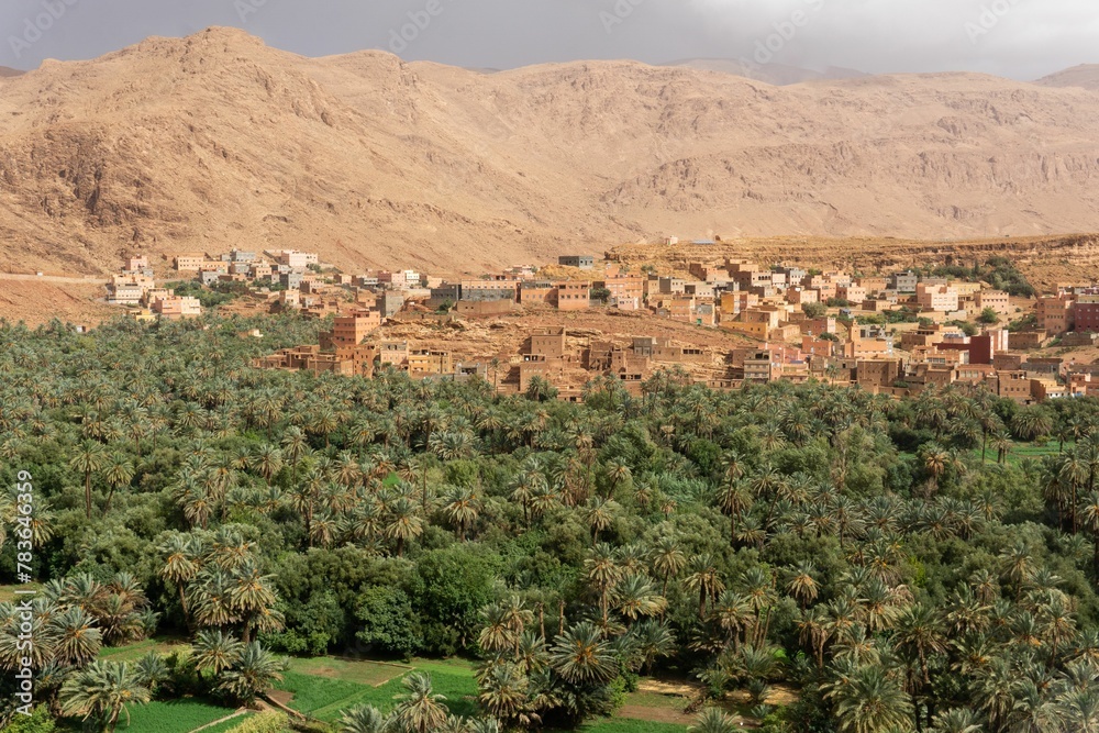 Ouarzazate city in Morocco in Sahara Desert surrounded by green trees and hills