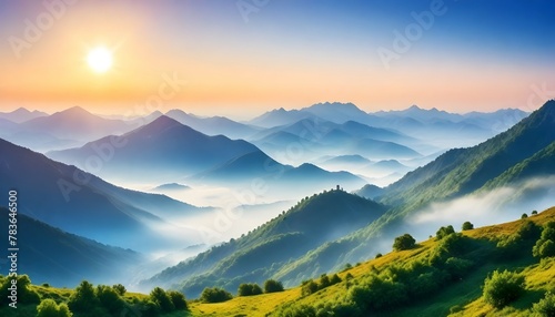 Beautiful landscape with mountains, mist and sun in the morning. Travel background.
