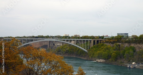 Bridge across Niagara, which connects two states of USA and Canada. Bridge connects people and improves economic ties across North America. Concept of uniting countries through bridges across river.