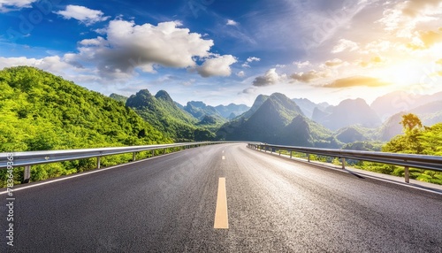 Asphalt highway road and green mountains with sky clouds nature landscape in the morning  photo
