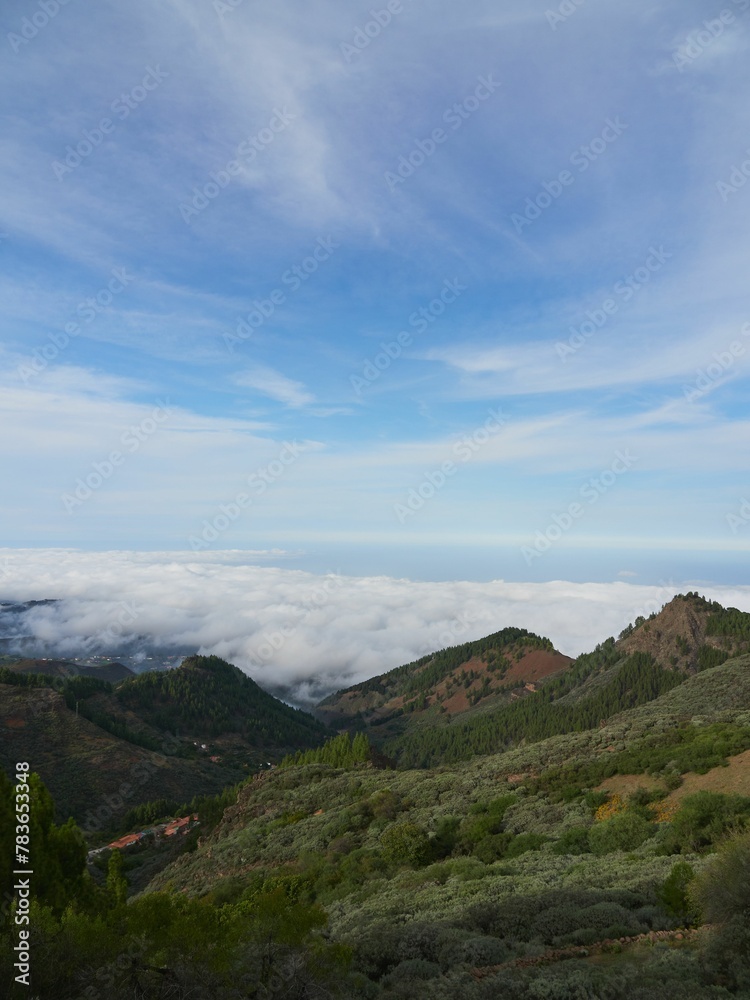 Mountain summits with sea of clouds in the background on a sunny day in Gran Canaria, Spain