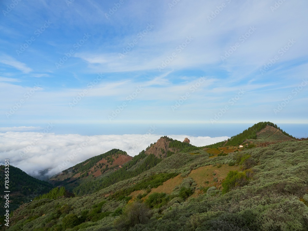 Landscape of the green mountain peaks with sea of clouds in the background in Gran Canaria, Spain