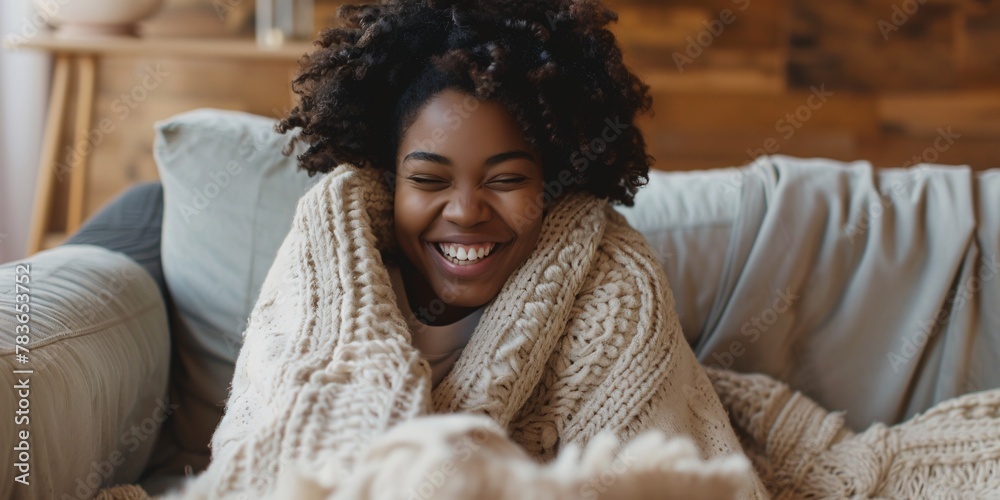 Gorgeous dark lady lounging at home, covered in cozy blanket and smiling with joy. Gorgeous dark lady lounging at home, covered in cozy blanket and smiling with joy.