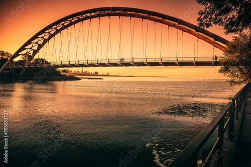 Photography Humber Bay Arch Bridge seen above Lake Ontario reflecting the beautiful sunset s