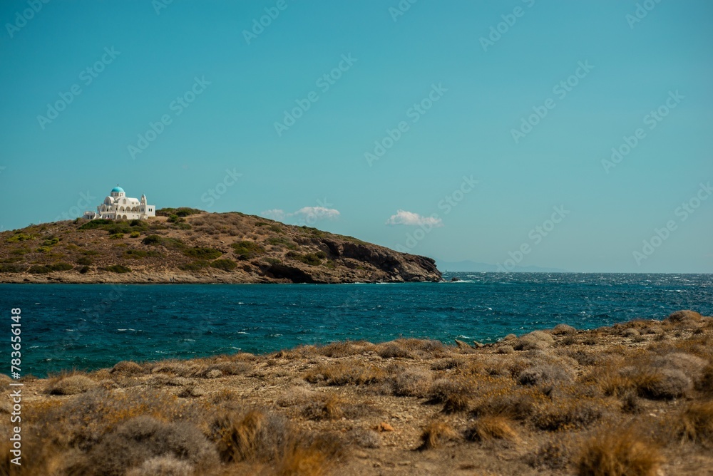 Image of a island with a white building on it surrounded with water