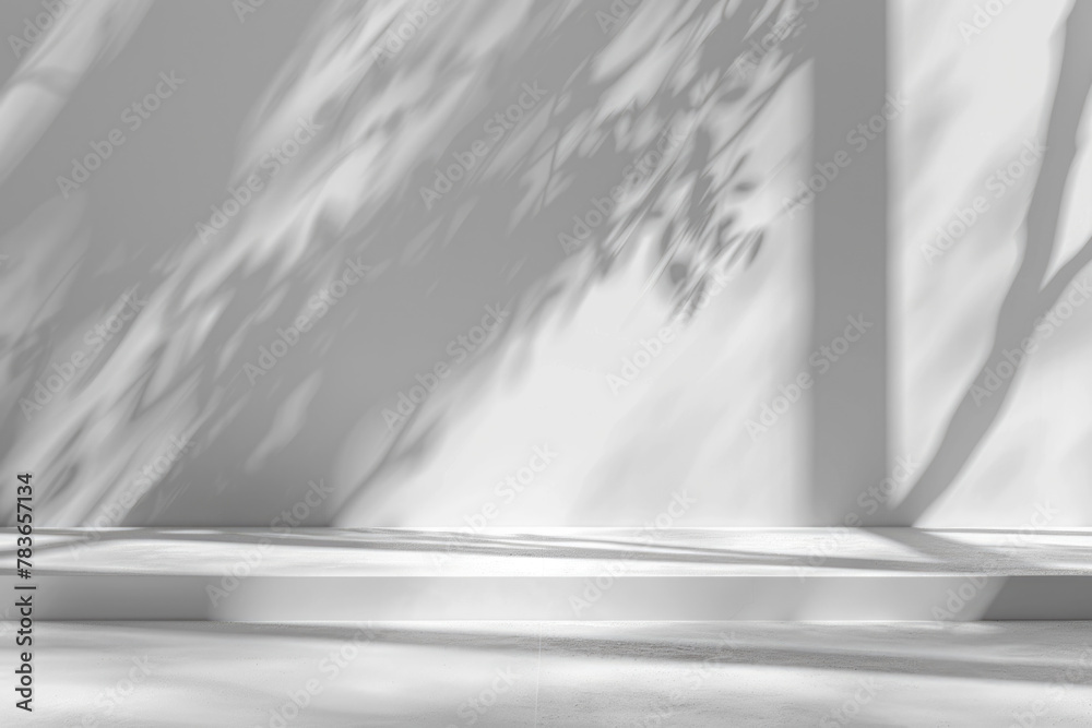 Minimalistic abstract light grey wall background for product presentation with sunlight shadow of plant leaves