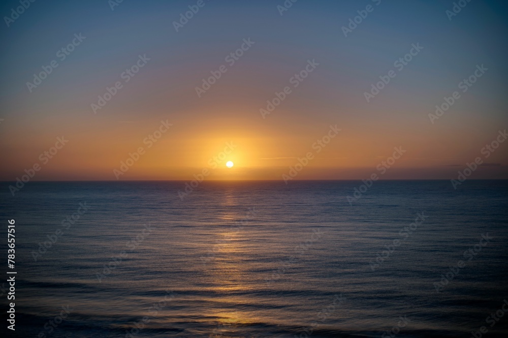 Beautiful shot of a bright sunset sky over the blue sea Beautiful shot of a bright sunset sky over the blue sea