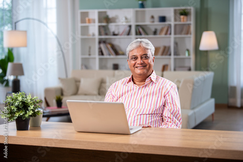 Photography Indian asian senior man using laptop computer at home