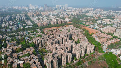 aerial drone shot slow pan of houses, homes, skyscrapers multi story apartments offices in delhi gurgaon showing the densely populated city photo