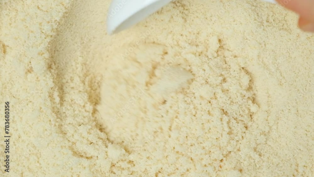 Almond flour close-up, cook stirring flour with spoon top view slow motion. Almond flour close-up, cook stirring flour with spoon top view slow motion.