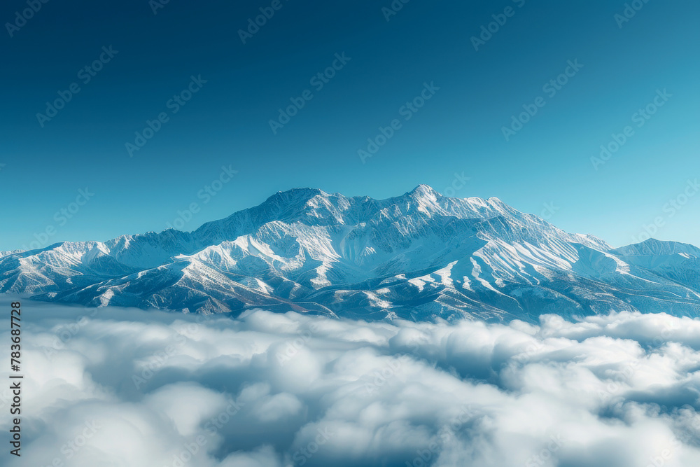 Serene Mountain Peak Above Clouds in Vivid Blue Skies