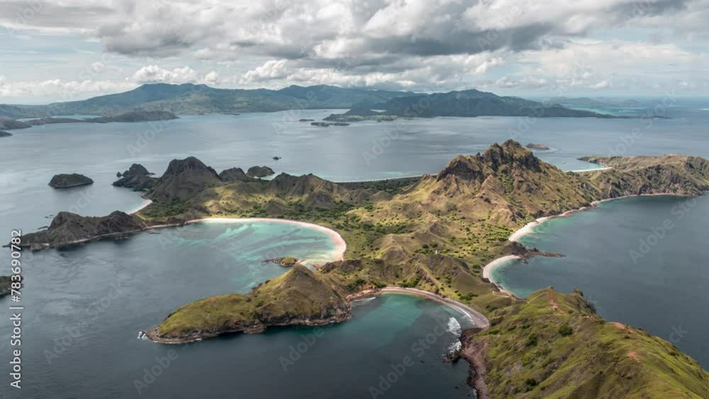 Aerial time lapse of clouds passing over Padar island with beautiful pink beaches and bays in Komodo national park, Indonesia