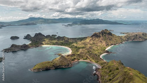 Aerial time lapse of clouds passing over Padar island with beautiful pink beaches and bays in Komodo national park, Indonesia photo