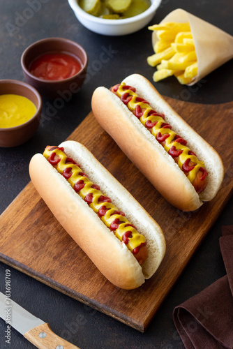 Hot dogs with grilled sausages, ketchup and mustard. Fast food.