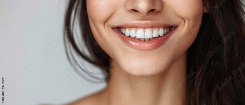 close-up of beautiful smiling teenage woman face showing clean healthy white teeth and beautiful lips on clear pastel color background close-up of beautiful smiling teenage woman face showing clean healthy white teeth and beautiful lips on clear pastel color background