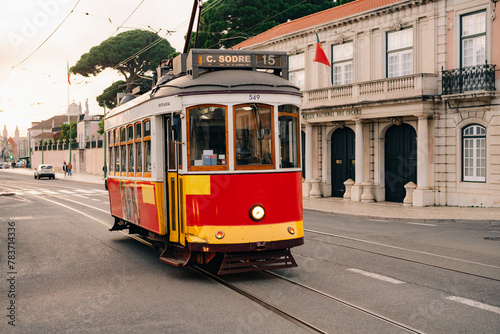 Iconic vintage yellow tram 15 traversing the charming streets of Lisbon, Portugal, a symbol of the city's heritage and a must-visit tourist attraction.