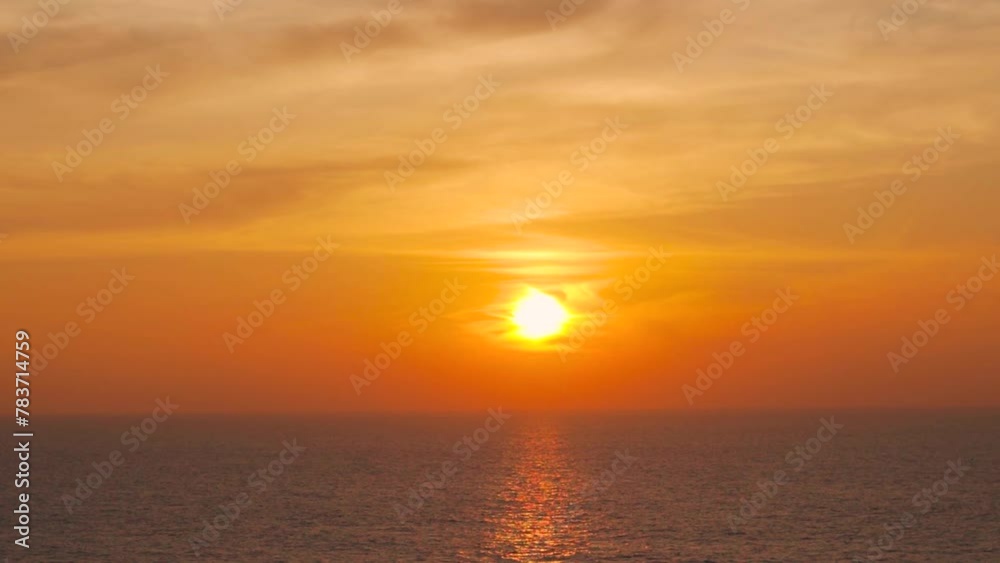 Sunset or sunrise over the sea with reflection of golden light on waves of ocean. Nature landscape. Beautiful sunset beach background during summer vacation evening. Sunset or sunrise over the sea with reflection of golden light on waves of ocean. Nature landscape. Beautiful sunset beach background during summer vacation evening.