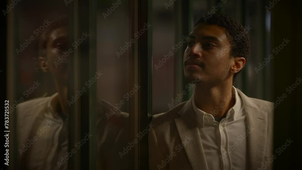 Young Man Waiting Alone at Train Station Platform at Night Young Man Waiting Alone at Train Station Platform at Night