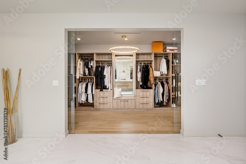 an empty walk in closet with lots of drawers and hanging items