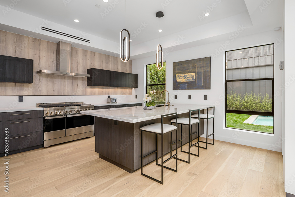 a kitchen with a center island and stools next to the stove a kitchen with a center island and stools next to the stove