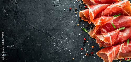 Thinly sliced jamon slices on a dark background with copyspace for your text, gourmet food
 photo