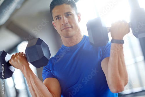Fitness, bodybuilder or man with dumbbells in workout, training or exercise for grip power. Strong guy, bodybuilding or serious athlete with heavy weights for pump, sports challenge or energy in gym