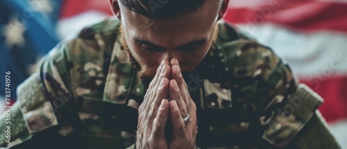 An intimate portrait of a soldier in prayerful contemplation, with the American flag in the background.