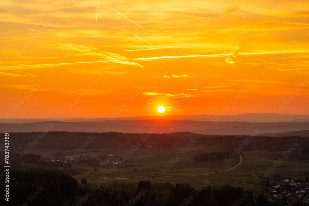 Panorama of a Romanesque landscape at sunset in the evening light. beautiful spring landscape in the mountains. Grass field and rolling hills. View from a rock to the horizon Panorama of a Romanesque landscape at sunset in the evening light. beautiful spring landscape in the mountains. Grass field and rolling hills. View from a rock to the horizon