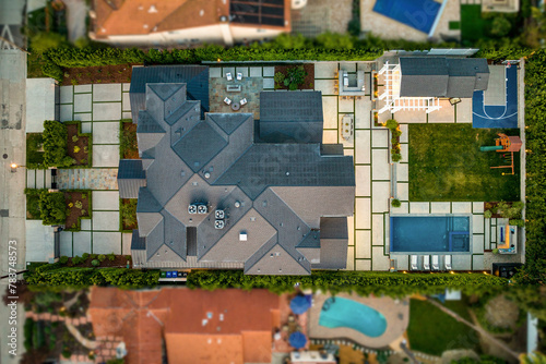 Aerial view of a luxury house with a pool.
