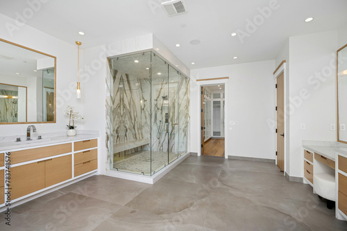 a large bathroom with shower and vanity area for the couple
