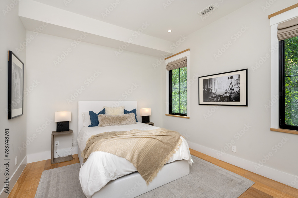 Fototapeta premium a bed that is in a bedroom with a wooden floor