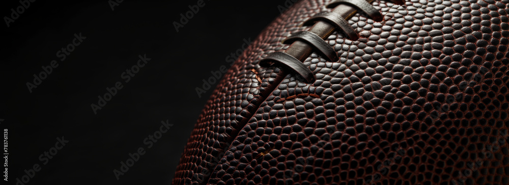 American football ball close-up texture on black background, copy space American football ball close-up texture on black background, copy space