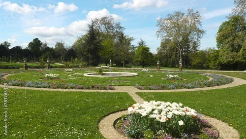 Pan over the rose garden in the Bagatelle park at springtime. It was built in 1835. It is located in Boulogne-Billancourt near Paris, France