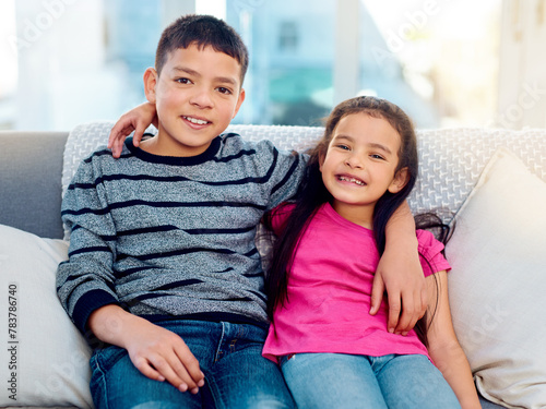 Siblings, hug and portrait of children in home, relax on sofa with care or support in happy family. Brother, sister or kids embrace with love, kindness or friends on holiday or vacation with respect
