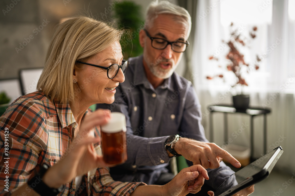 Mature couple husband and wife read recipe and instructions for medicament Mature couple husband and wife read recipe and instructions for medicament
