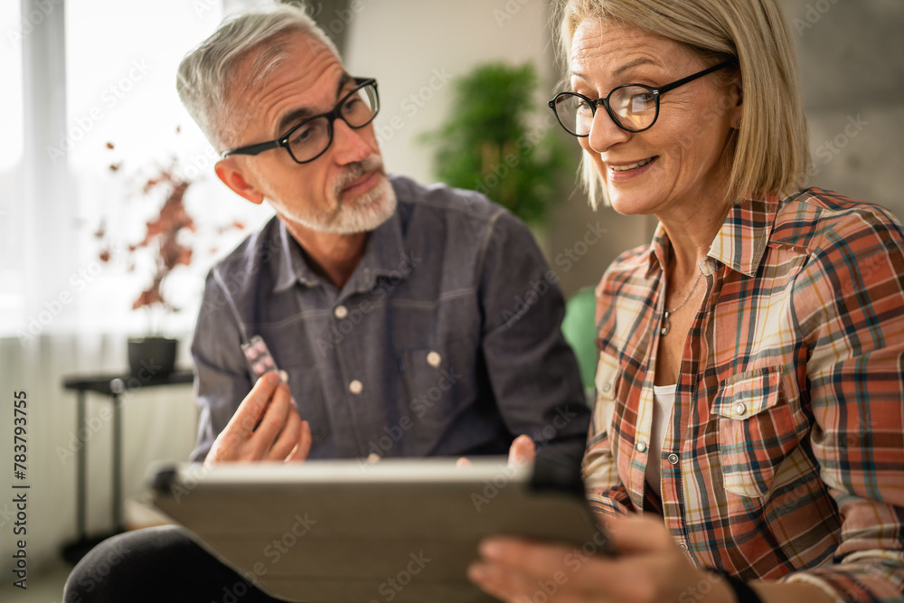 Mature couple husband and wife read recipe and instructions for medicament Mature couple husband and wife read recipe and instructions for medicament