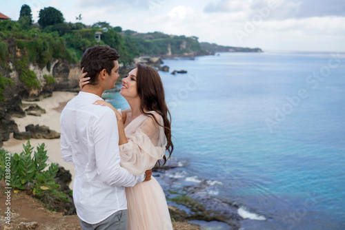 Young couple in love enjoying the water view in Bali