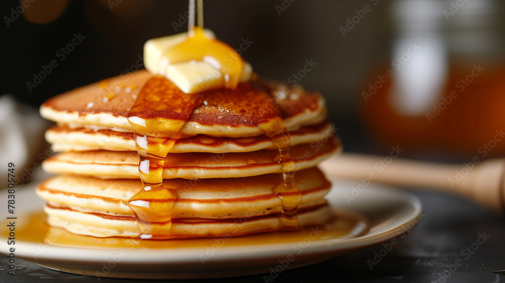 Stack of homemade pancakes topped with honey and chocolate syrup on a white plate with butter, a sweet morning treat Stack of homemade pancakes topped with honey and chocolate syrup on a white plate with butter, a sweet morning treat